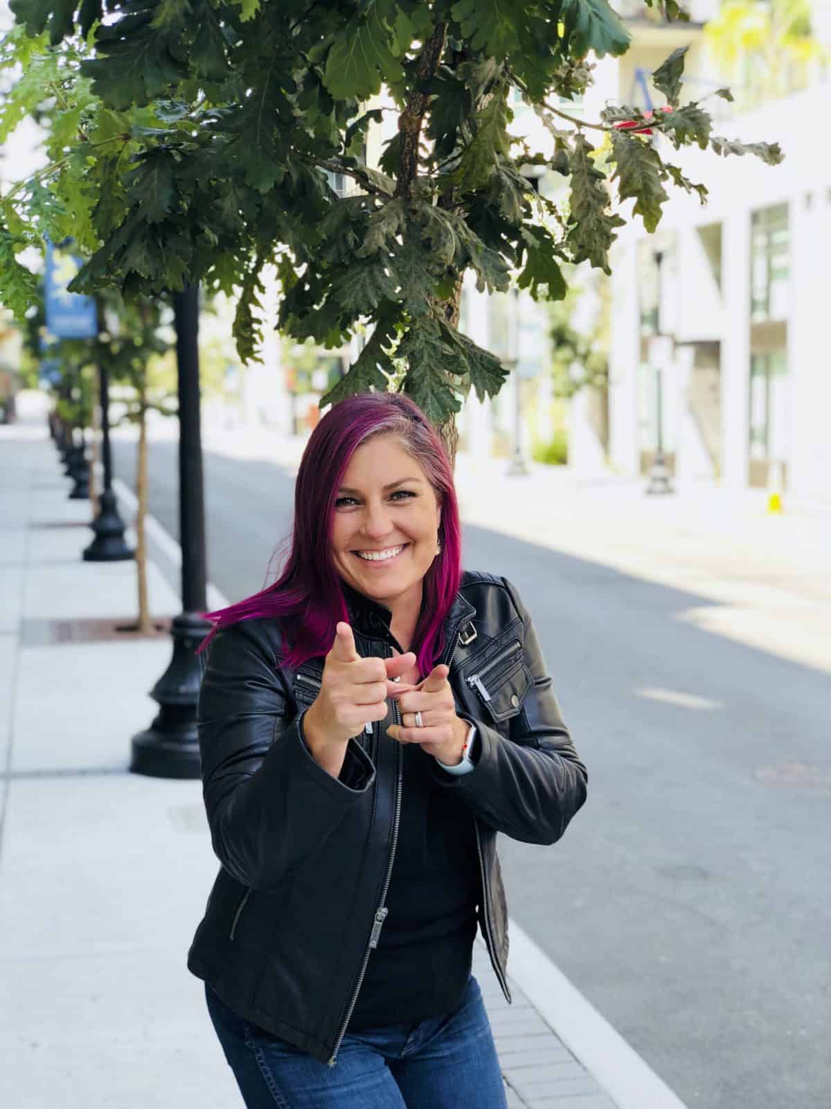 Profile photo of laura with pink hair and leather jacket.