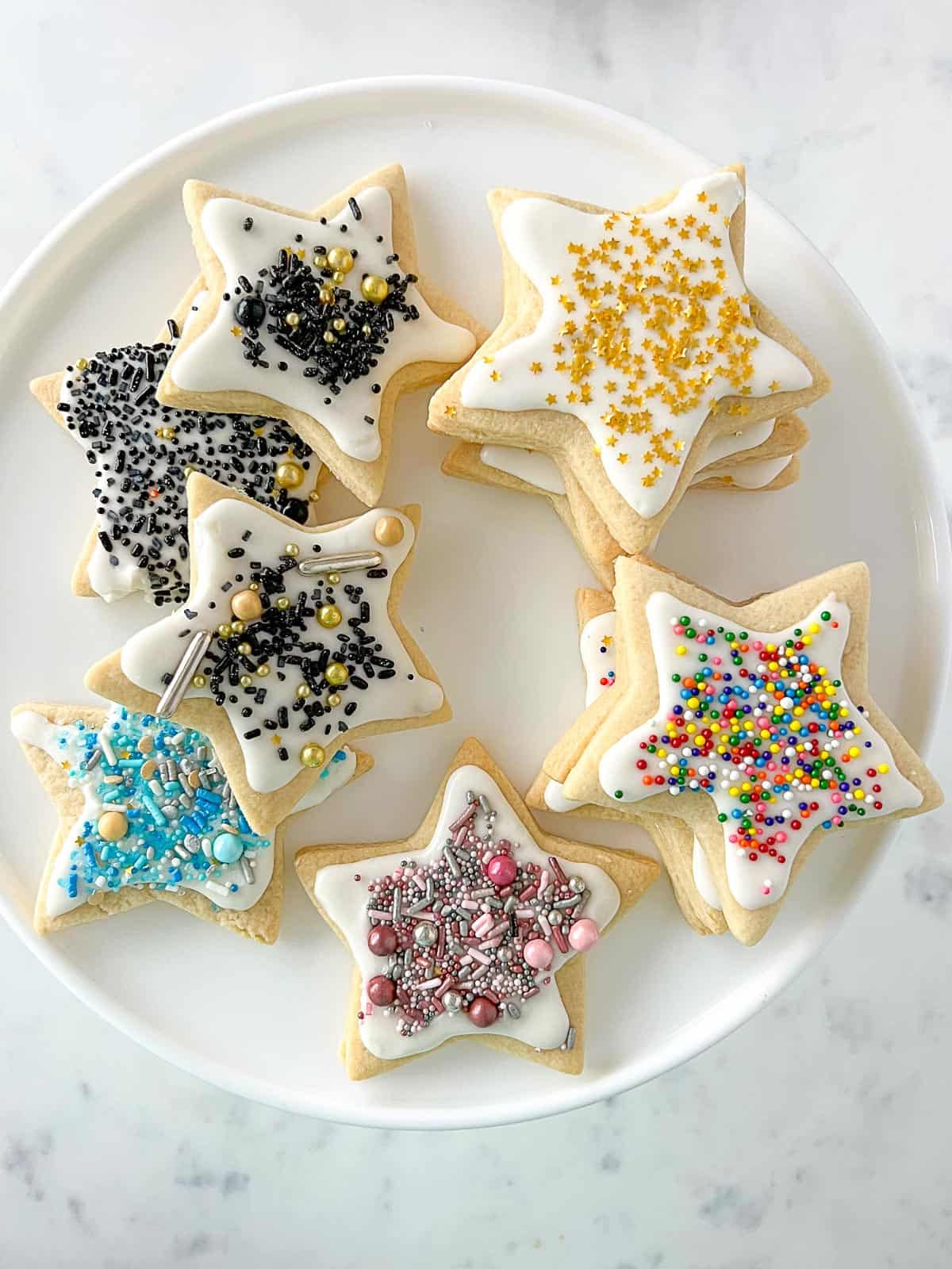 star shaped sugar cookies with royal icing and sprinkles